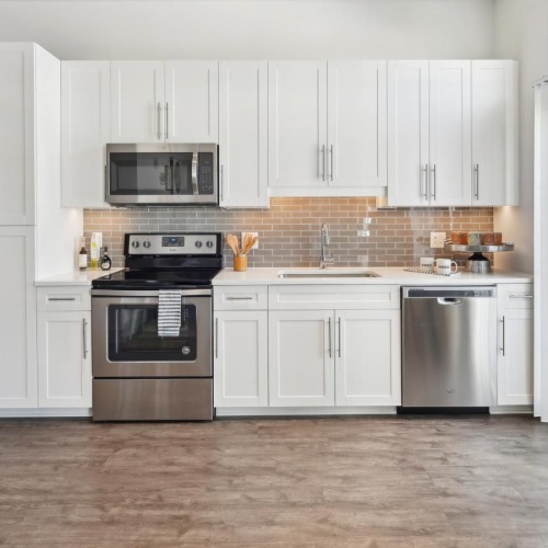 Spacious kitchens with thoughtful details a kitchen with white cabinets