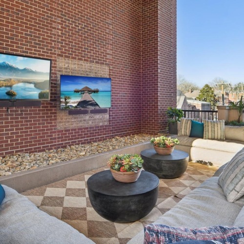 Everything within reach a living room with a brick wall