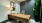 desk with seating lamp and large plant