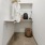 a white room with a shelf and a basket with clothes on it