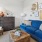 a living room with a blue couch and a coffee table
