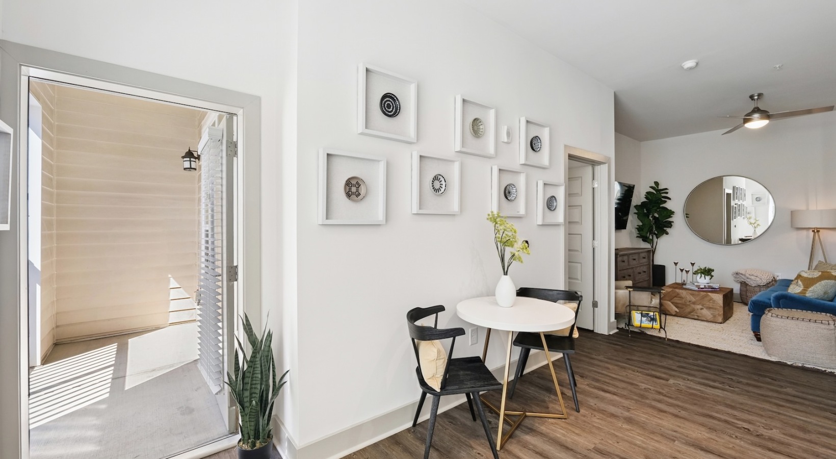Spacious and well-lit living spaces dining area with door to patio