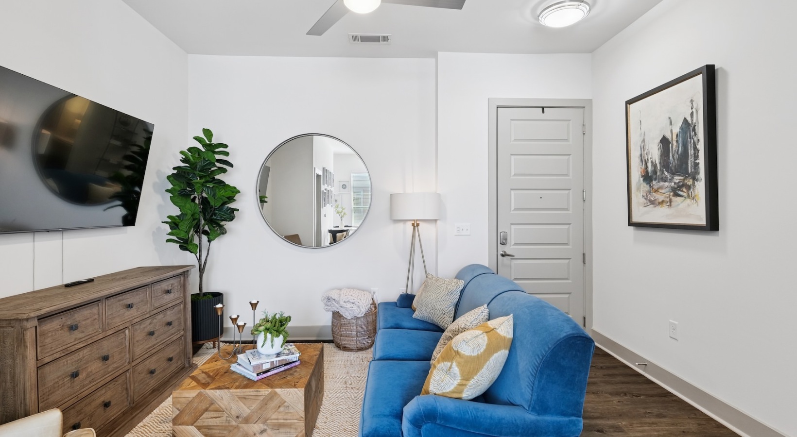 Generous living spaces to relax and unwind living room with blue couch and ceiling fan